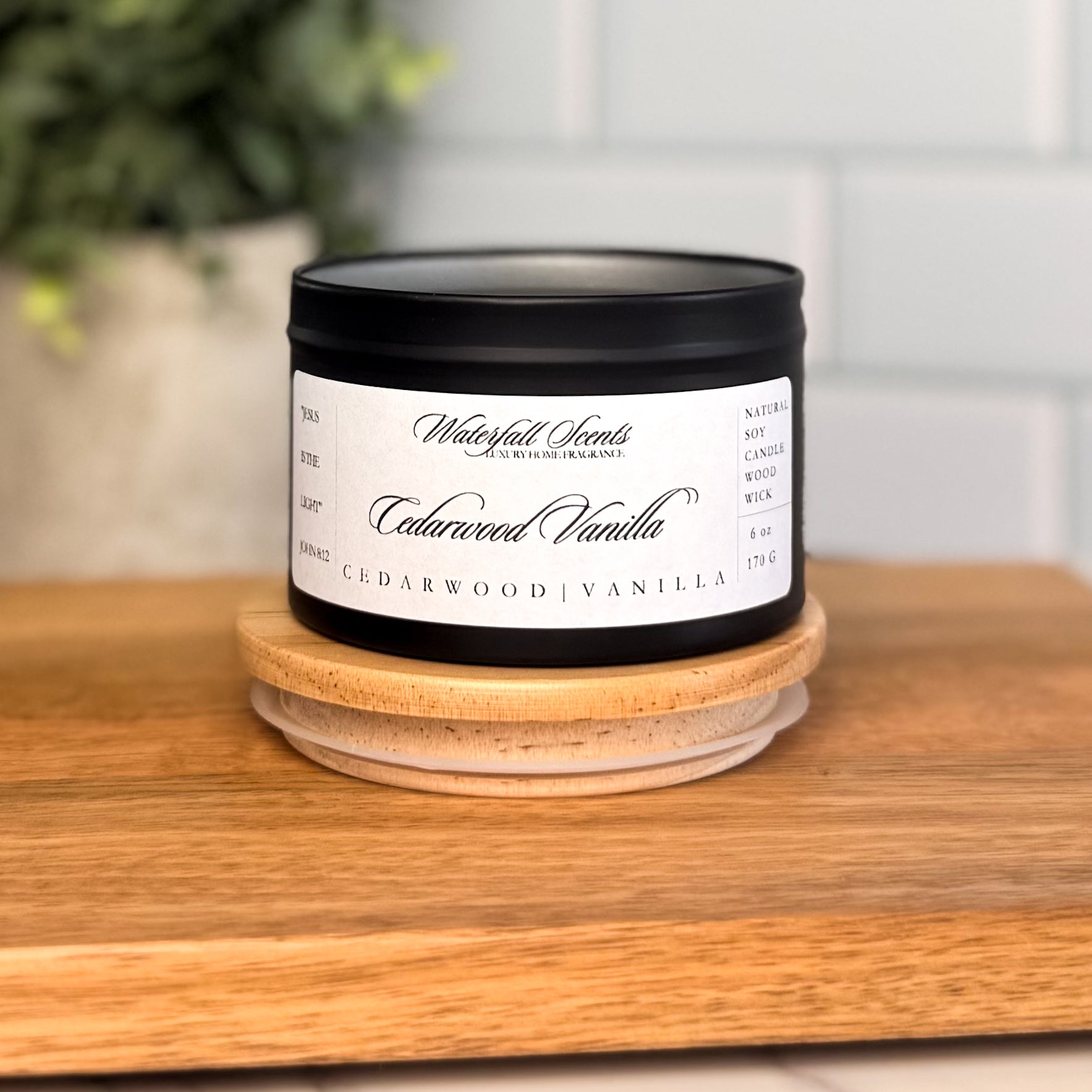 Cedarwood Vanilla candle in a black travel tin with a white label. A best natural candle with a wooden wick, perfect for cozy spaces and Christian homes.