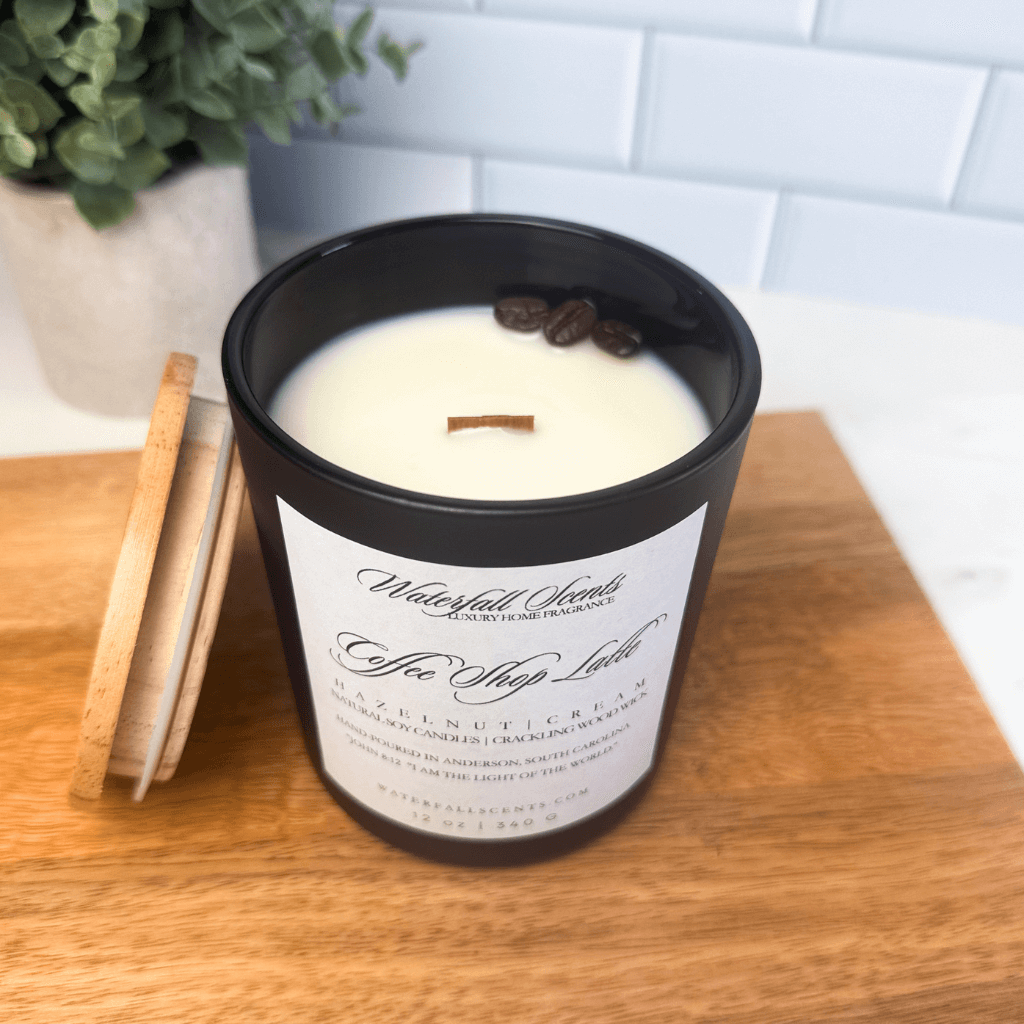 Elegant black glass jar candle with a wooden wick, offering a natural, clean-burning experience with warm hazelnut coffee, vanilla, and sweet cream notes.