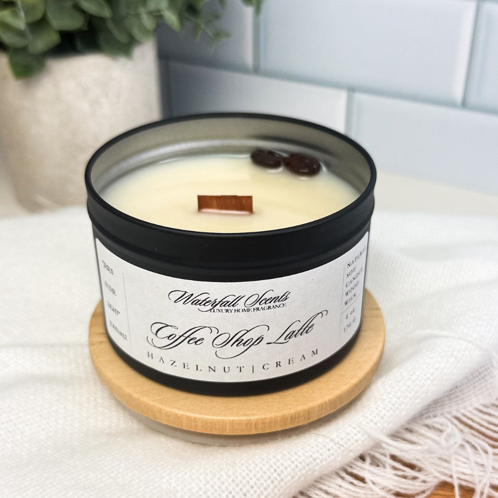 Compact tin jar candle with a wooden wick, offering a cozy blend of coffee, vanilla, and sweet cream for a peaceful, clean-burning atmosphere.