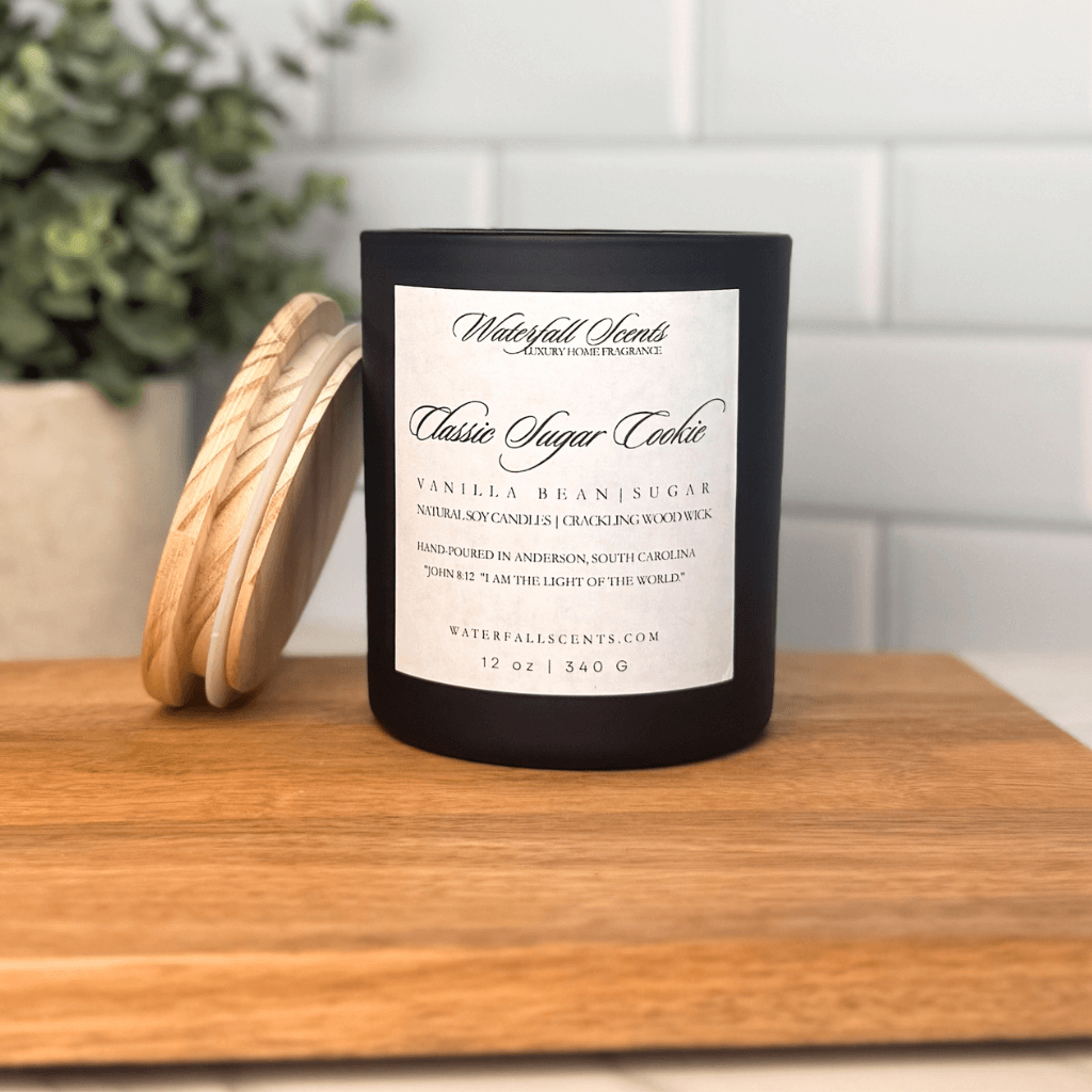 Classic Sugar Cookie wooden wick candle in a black glass jar with a white label. Hand poured, clean burning, natural, and non-toxic with sweet vanilla sugar cookie aroma.
