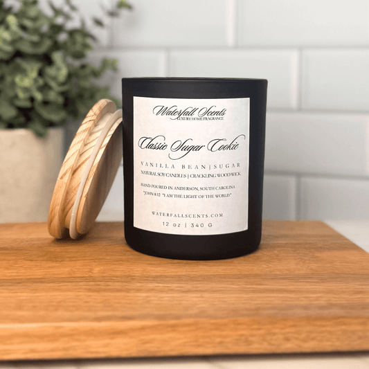 Classic Sugar Cookie wooden wick candle in a black glass jar with a white label. Hand poured, clean burning, natural, and non-toxic with sweet vanilla sugar cookie aroma.