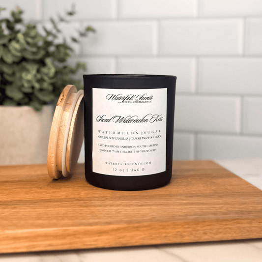 Sweet Watermelon Kiss wooden wick candle in a black glass jar with a white label. Hand poured with clean, non-toxic ingredients for a fresh, fruity scent.