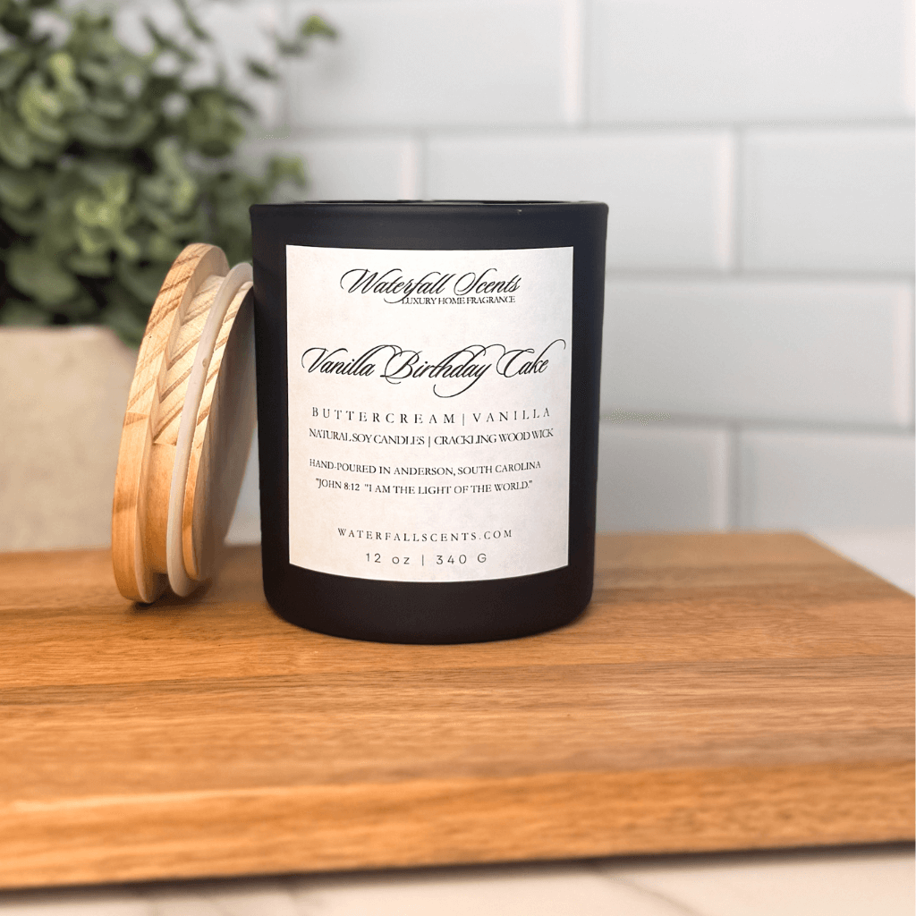Vanilla Birthday Cake wooden wick candle in a black glass jar with a white label. Hand poured, clean burning, and non-toxic with a sweet bakery scent.