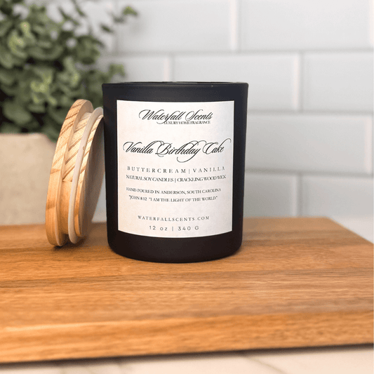 Vanilla Birthday Cake wooden wick candle in a black glass jar with a white label. Hand poured, clean burning, and non-toxic with a sweet bakery scent.