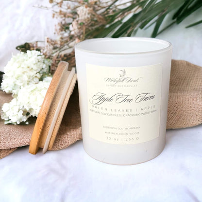 Apple Tree Farm Wooden Wick Candles - A charming display of handcrafted candles with wooden wicks, radiating a warm and inviting glow. Comes in white glass vessels