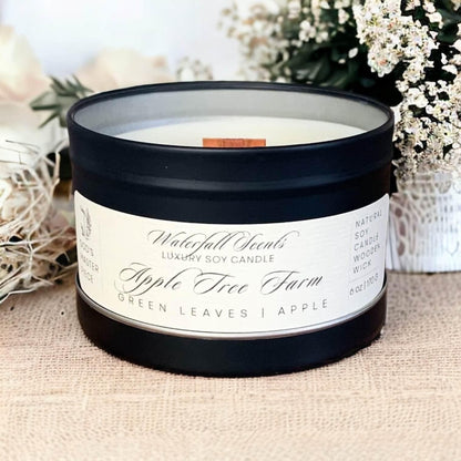 Apple Tree Farm Wooden Wick Candles - A charming display of handcrafted candles with wooden wicks, radiating a warm and inviting glow. Comes in black tin vessels