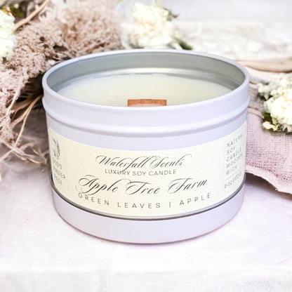 Apple Tree Farm Wooden Wick Candles - A charming display of handcrafted candles with wooden wicks, radiating a warm and inviting glow. Comes in white tin vessels