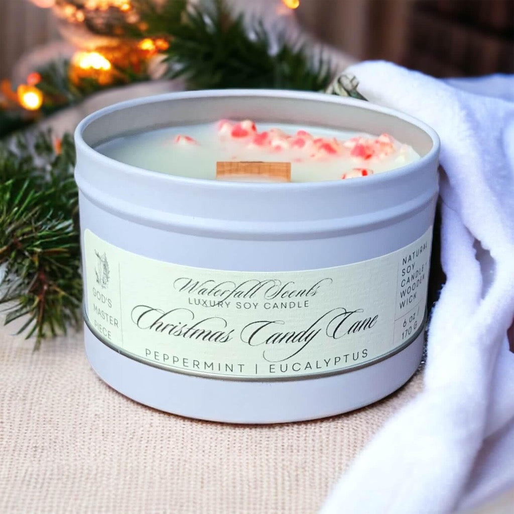 christmas candy cane wooden wick candle in a matte white travel tin on a burlap placemat