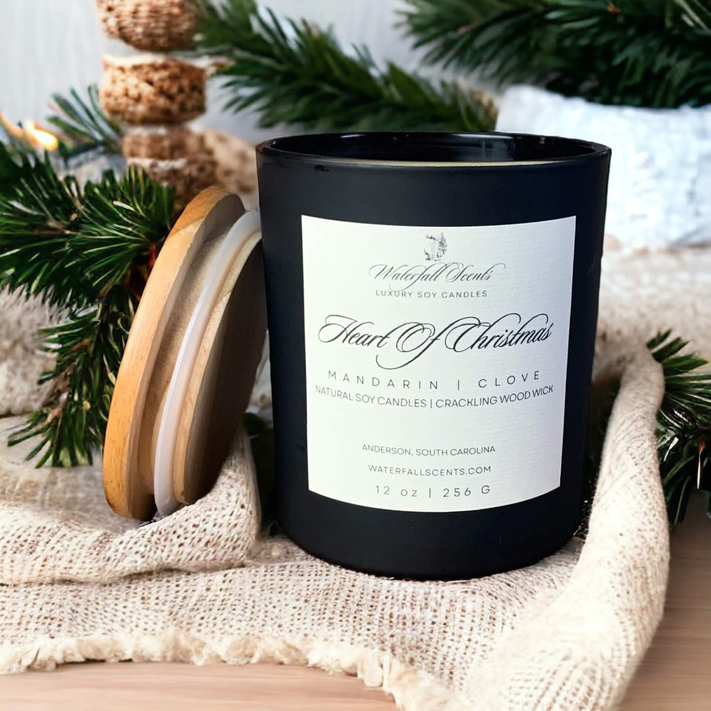 Matte black glass jar candles, infused with the heartwarming essence of Heart Of Christmas, featuring a wooden wick for a cozy and festive ambiance.