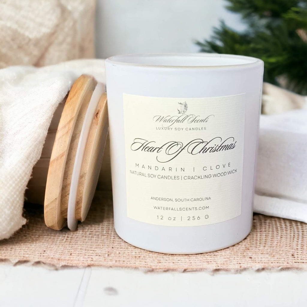 Matte white glass jar candles, evoking the festive spirit of Heart Of Christmas, enhanced by a wooden wick for a warm and inviting atmosphere.